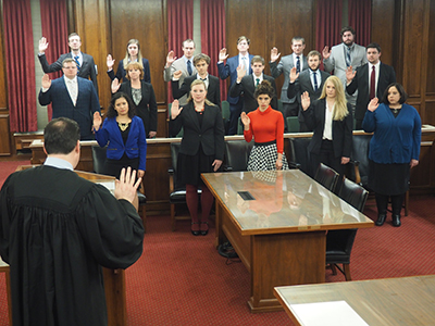 Group of students being sworn in by Judge Ebberts.