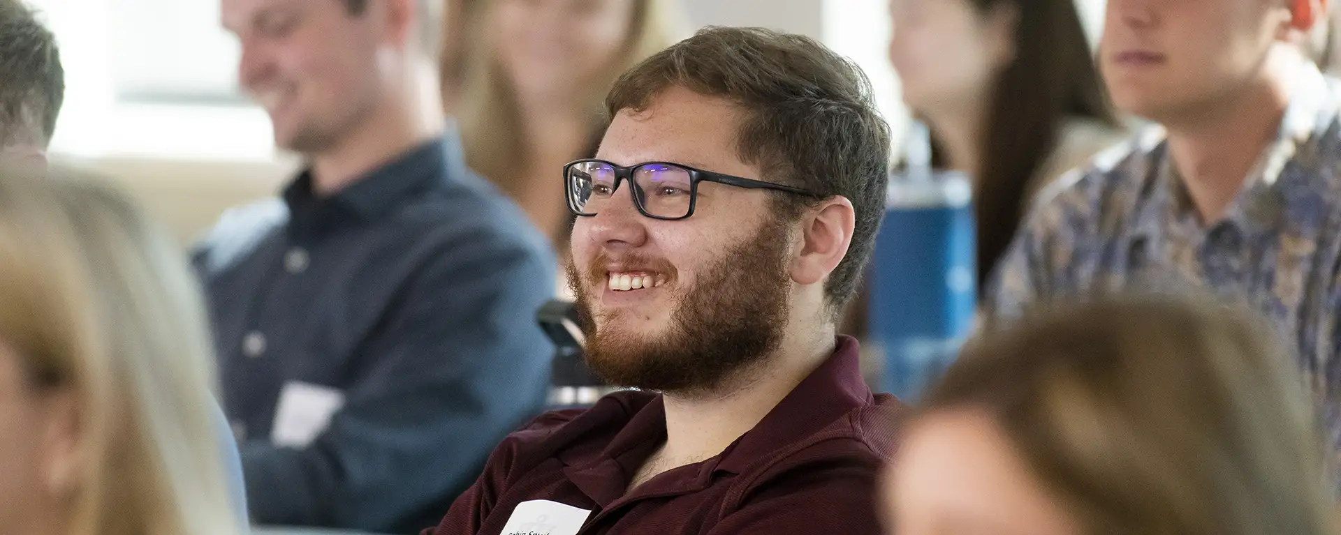 A law student smiles in class.