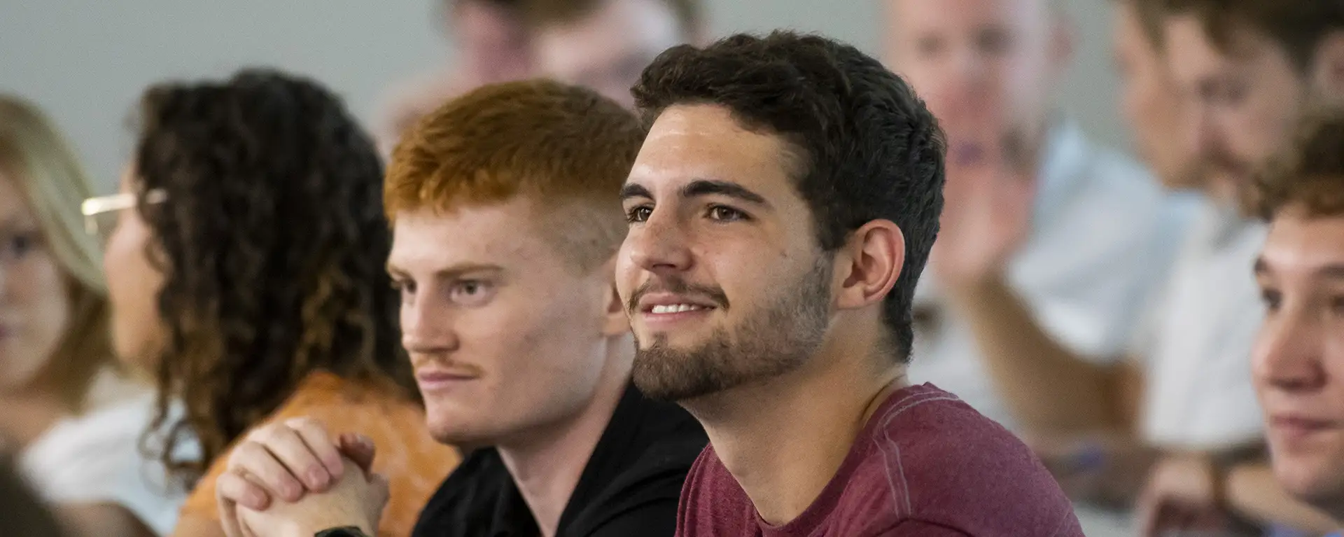 A law student smiles in class.