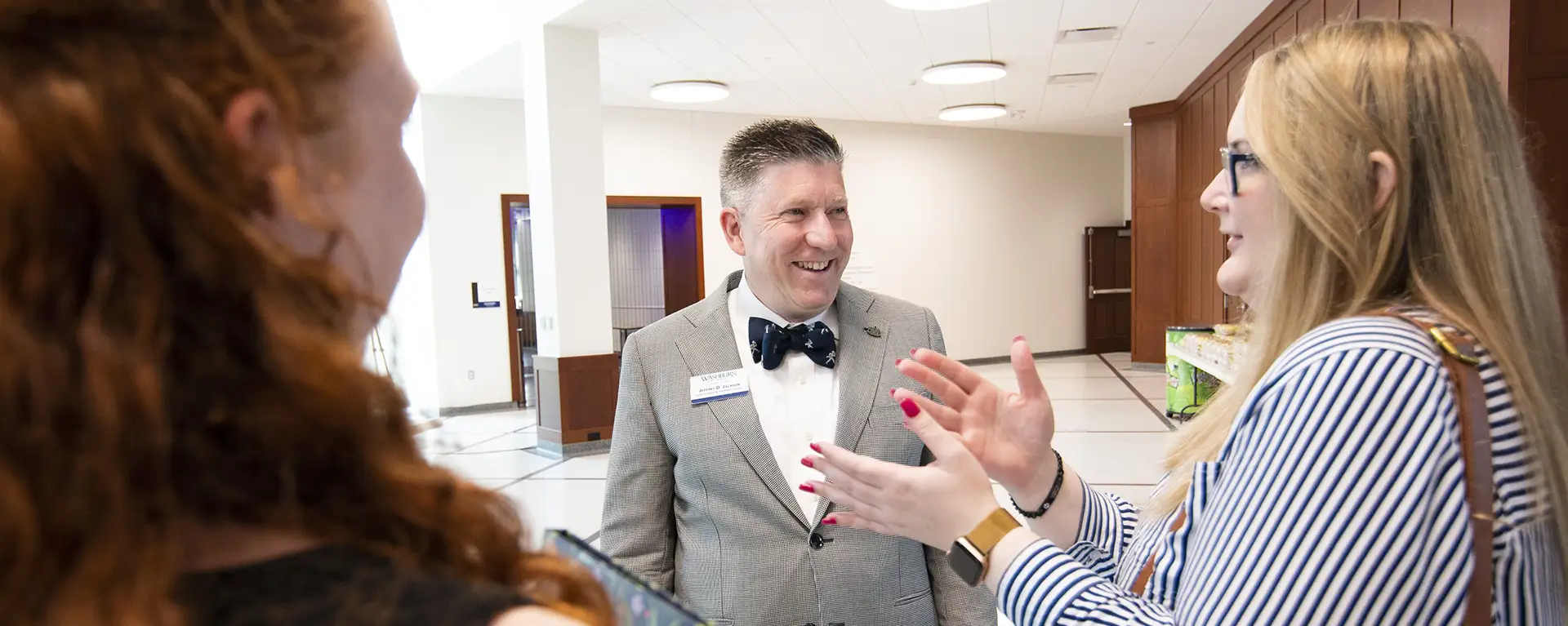 Dean Jeffrey Jackson speaks with two law students.