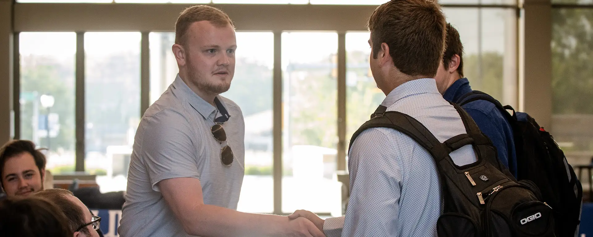 Two law students shake hands.