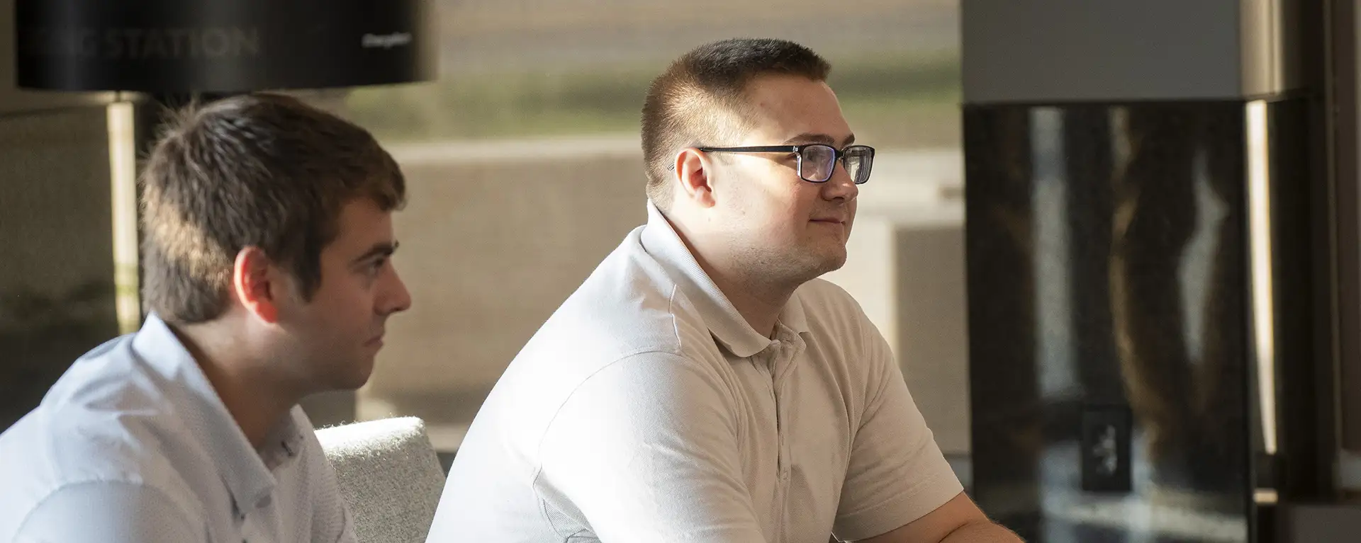 A student smiles while listening to a peer.