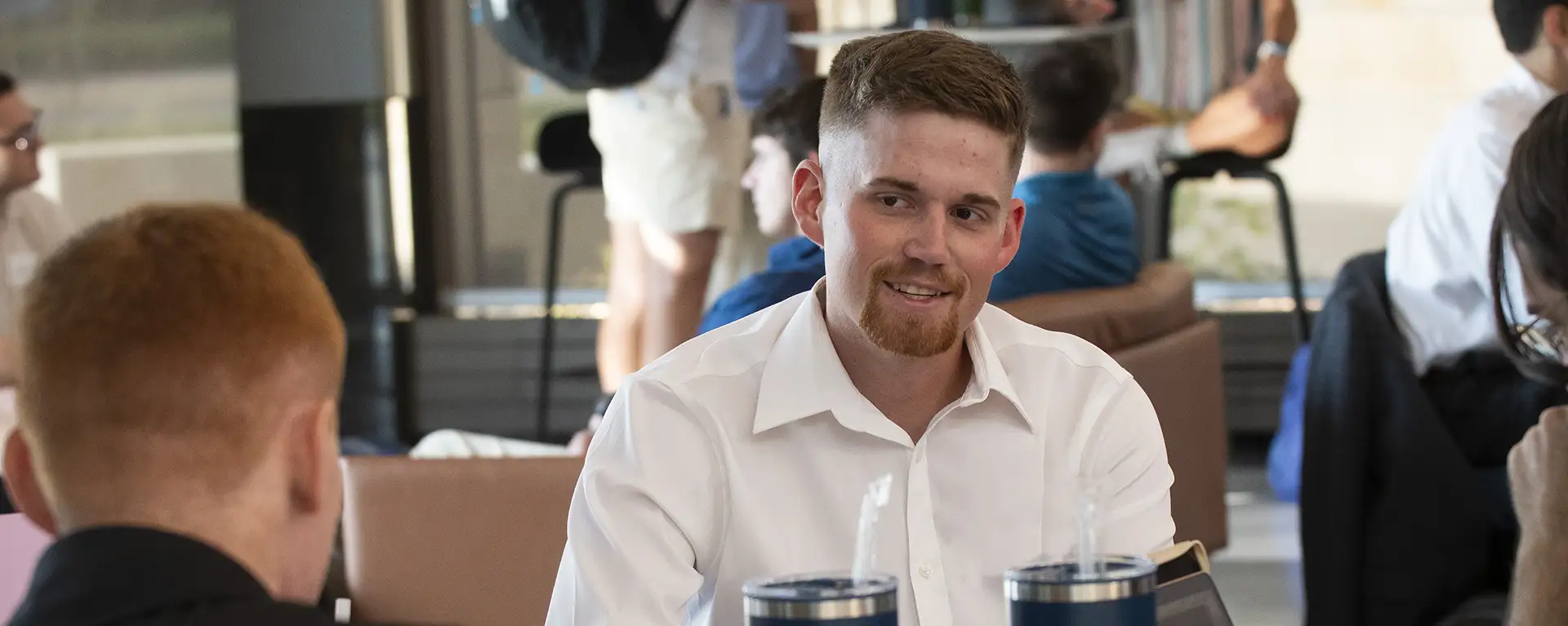 A law student smiles while having a conversation.