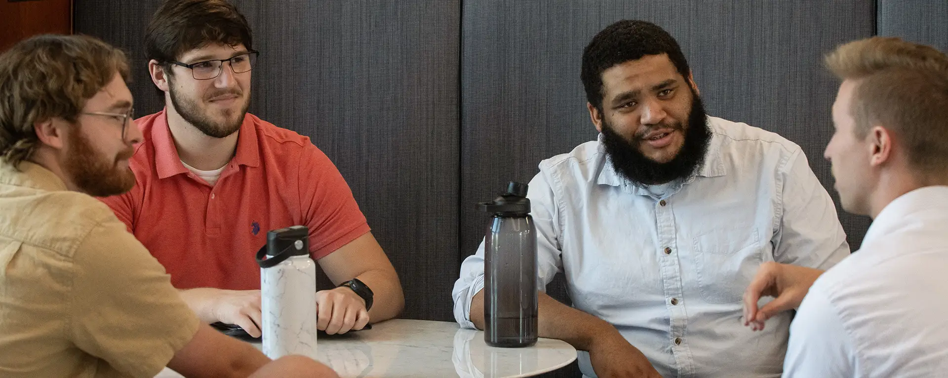 Law students smile and chat in a group.