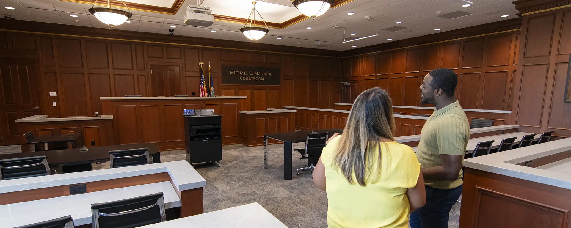 A student takes a tour of the trial courtroom at Washburn Law.