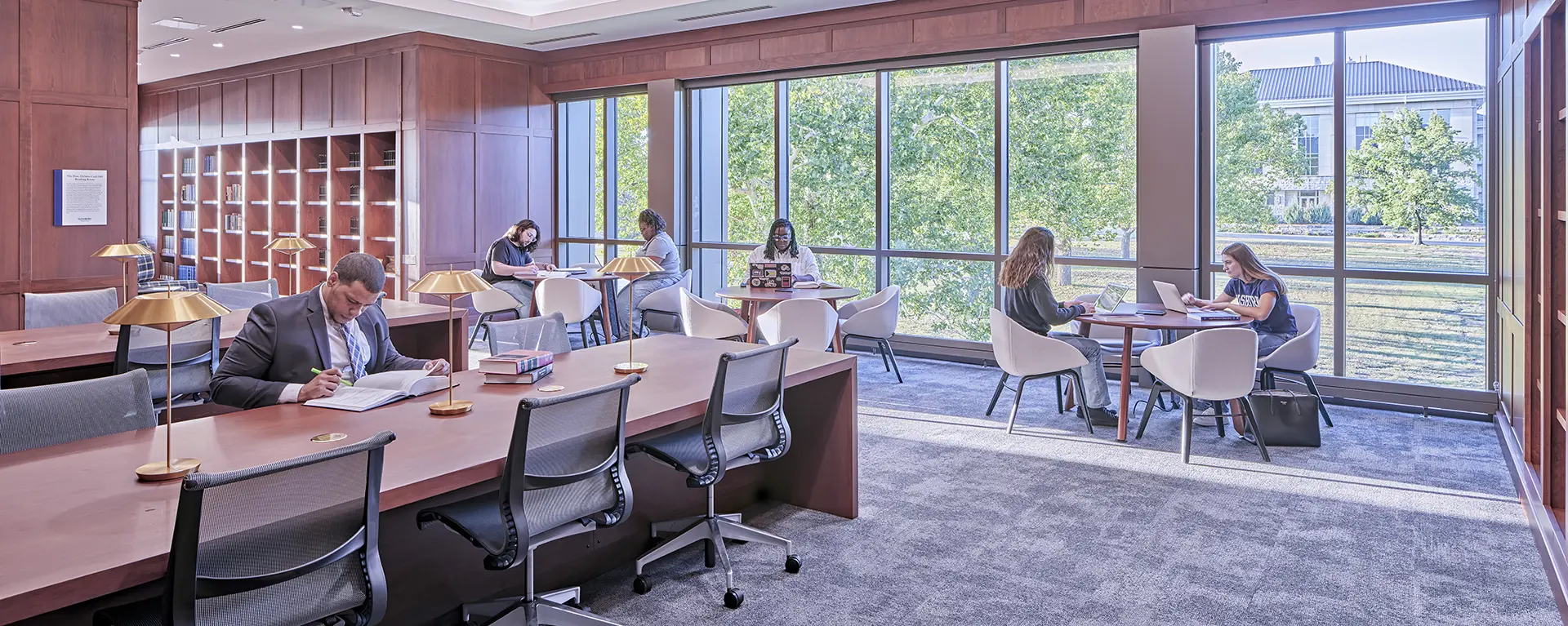 Students study in the reading room of the library.