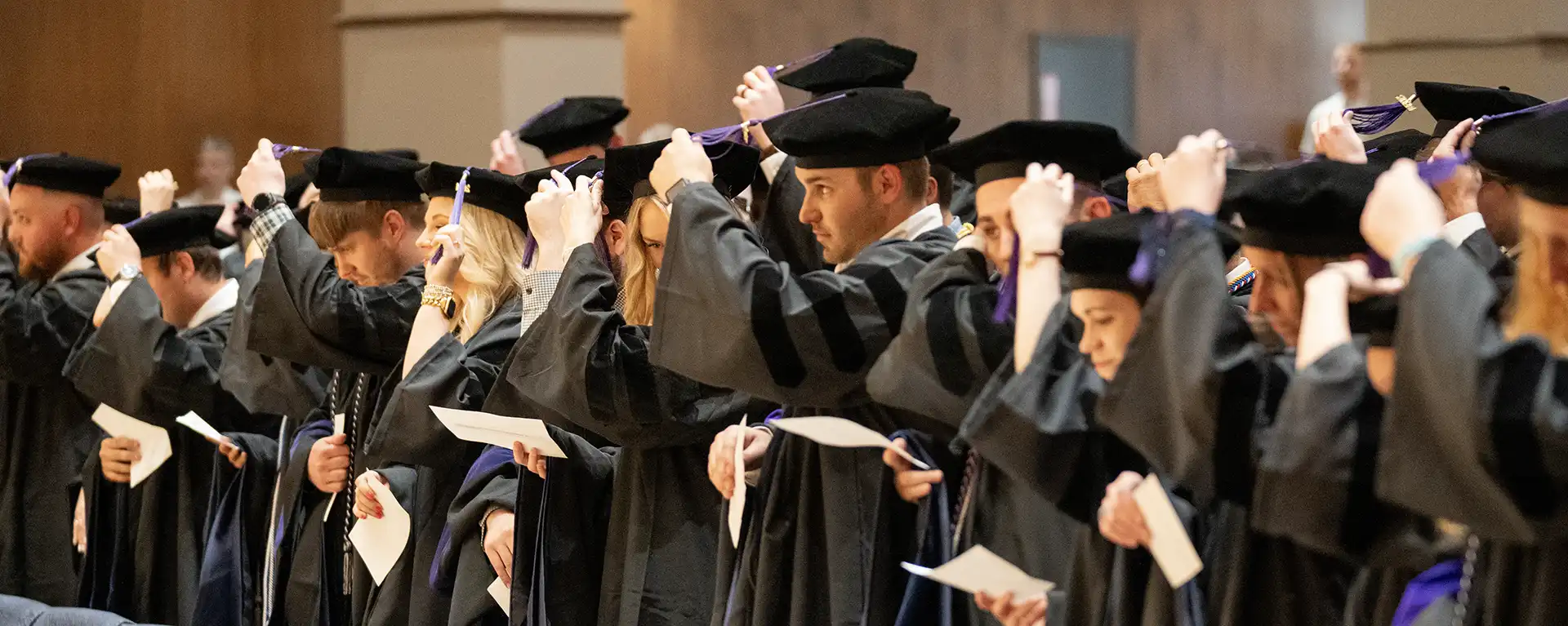 Graduates move their tassels during the commencement ceremony.