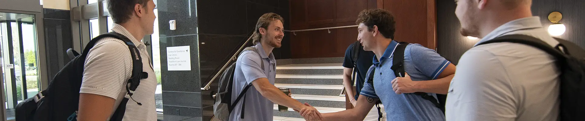 Students shake hands after meeting.