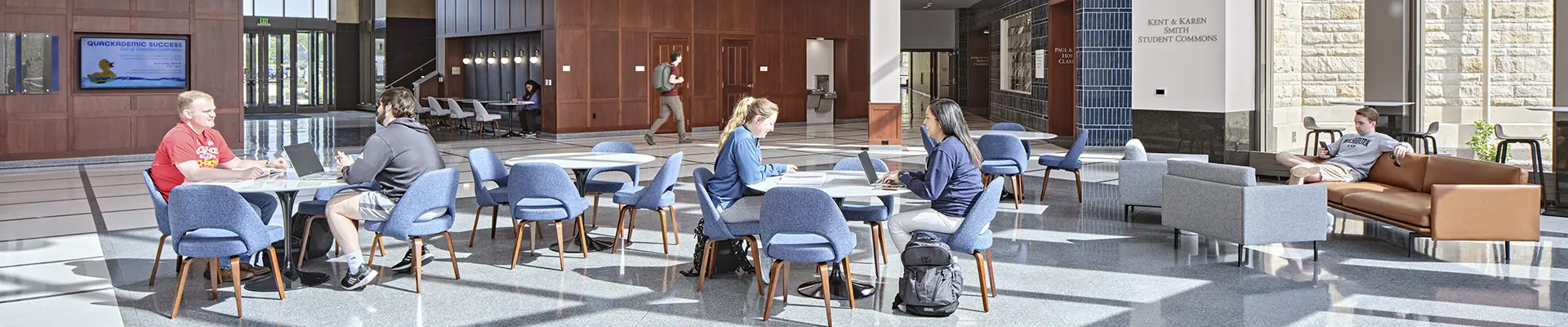 Students chat in the Dole Hall lobby.