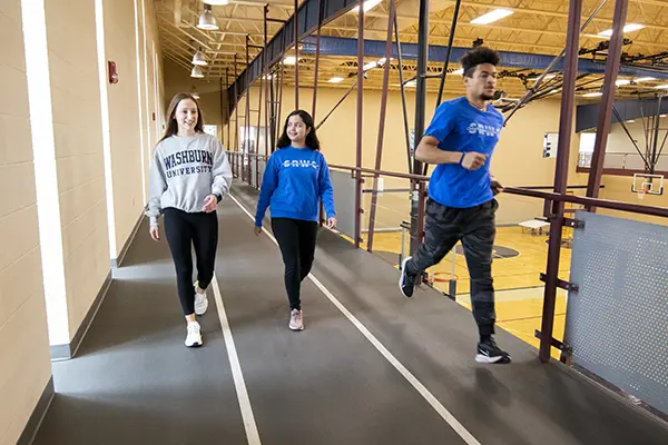 Students walk and run on the track in the SRWC.