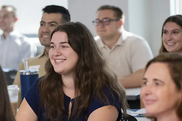 A student smiles while paying attention in class.