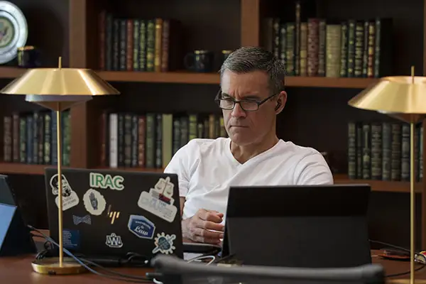 A student studies on his laptop in the library.