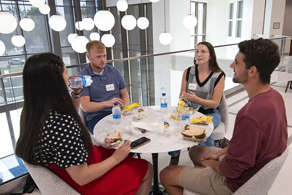 Students talk over boxed lunches.