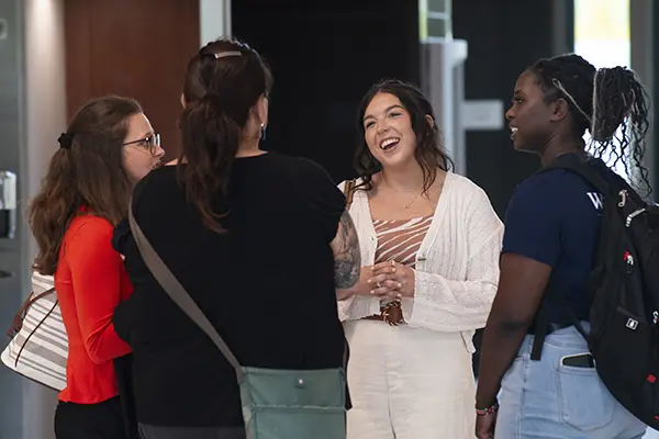 Students smiling while talking together.