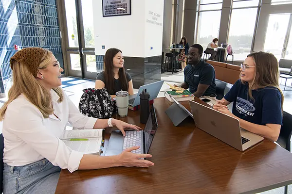 A tutoring group talks about an assignment.