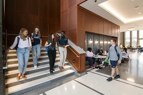 Students talk while walking to class.