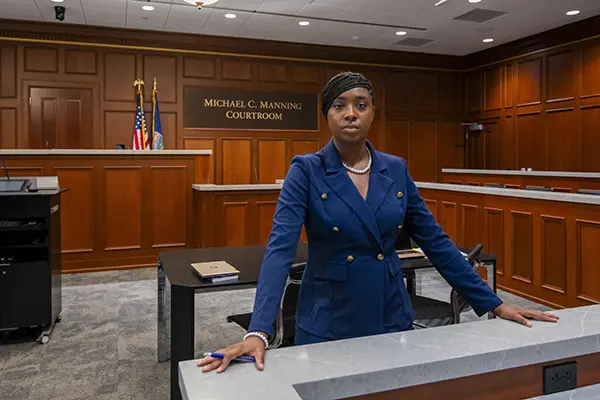 A law student stands in the courtroom.