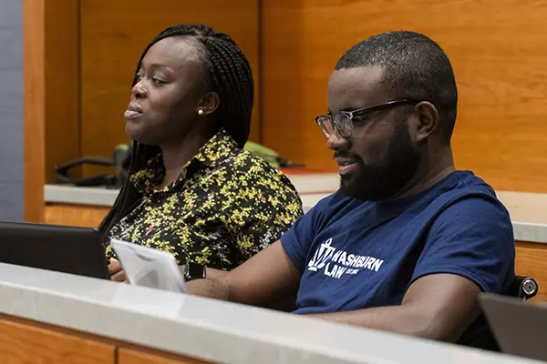 A law student takes notes during class.