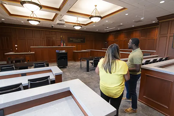 A law student takes a tour of the trial courtroom.