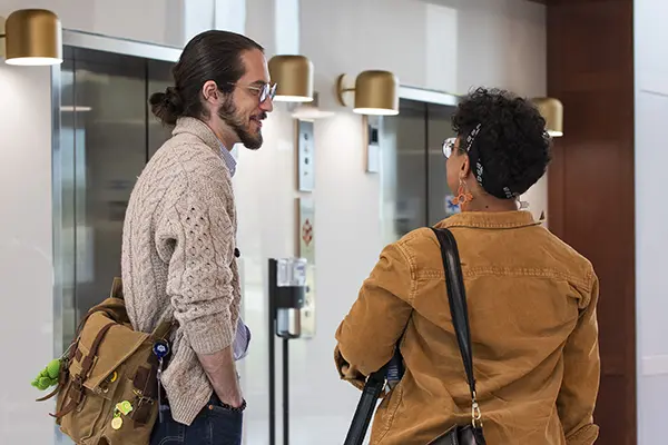 Two law students chat in the lobby.