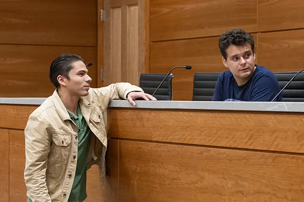 Students take a break from competition practice to chat in appellate courtroom. 