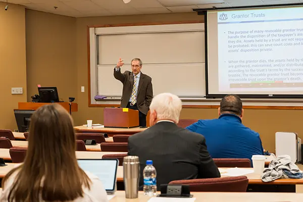 A law professor gestures while giving CLE training.