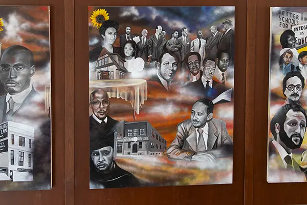 The second panel of the mural features many black and white photos of plaintiffs and attorneys involved in the case.