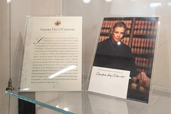 A picture of Sandra Day O'Connor, her signature and a biography about her on display as part of the collection.