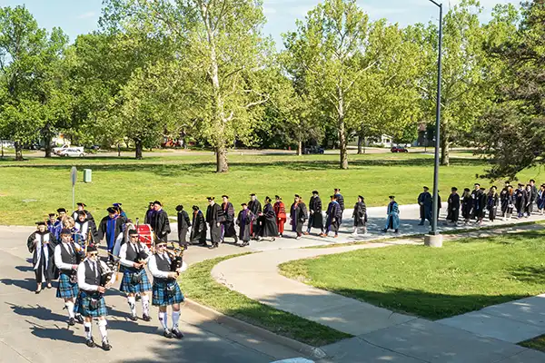 The commencement party parades across campus.