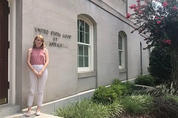 Student stands in front of Court of Appeals in Washington D.C. 